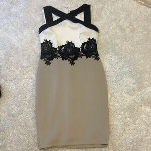 Tan, white and black cross cross dress with black floral appliqués around waist.